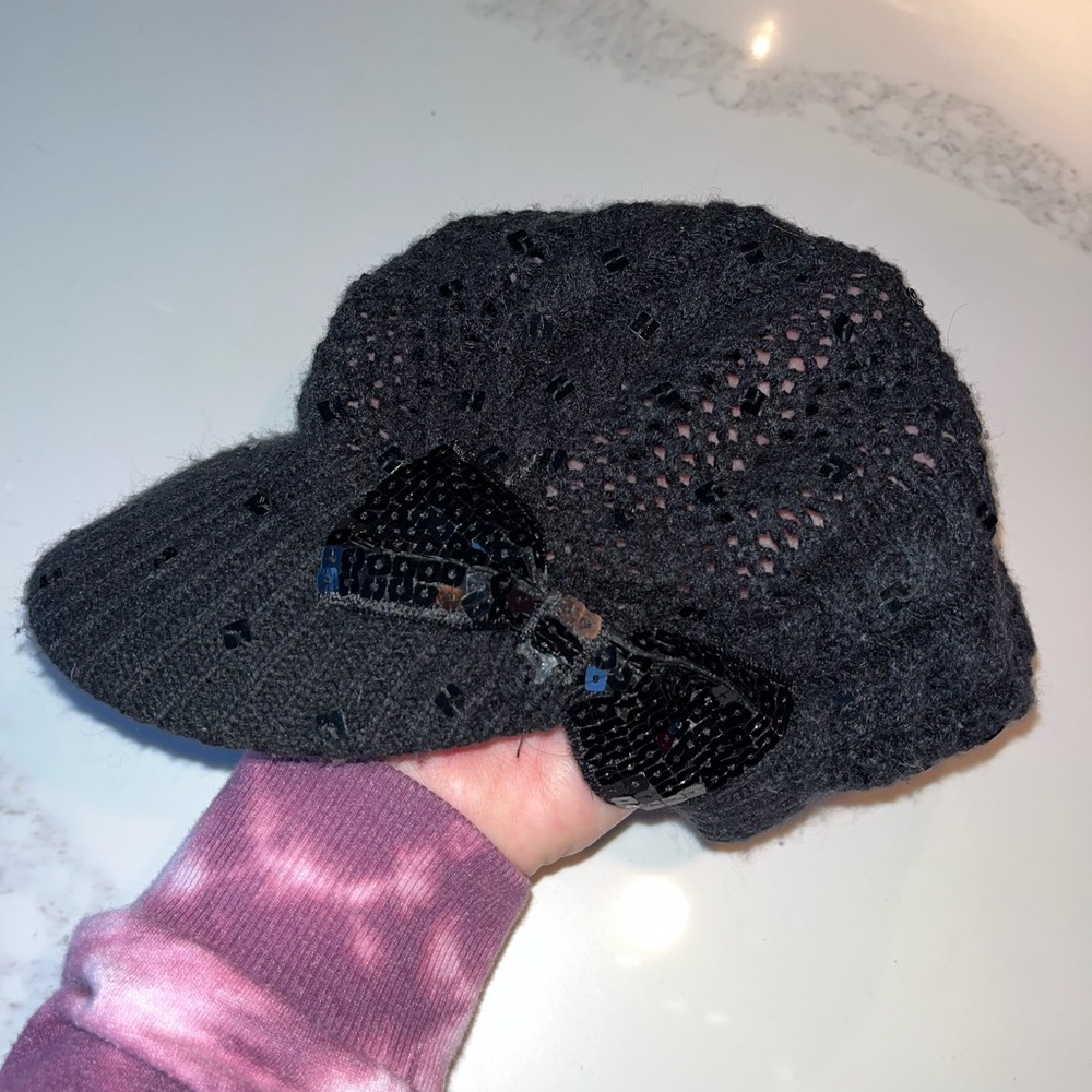 Fabulous black crocheted cap.  Sparkly bow on side. Justice one size fits all.